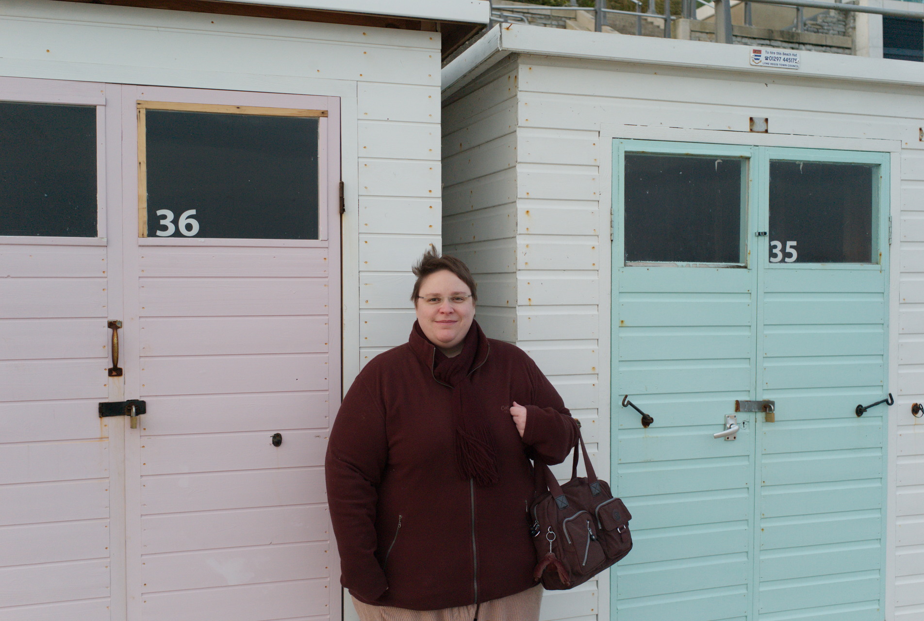 standing next to huts at lyme
